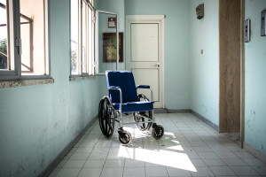 Wheelchair abandoned in in an old hospital